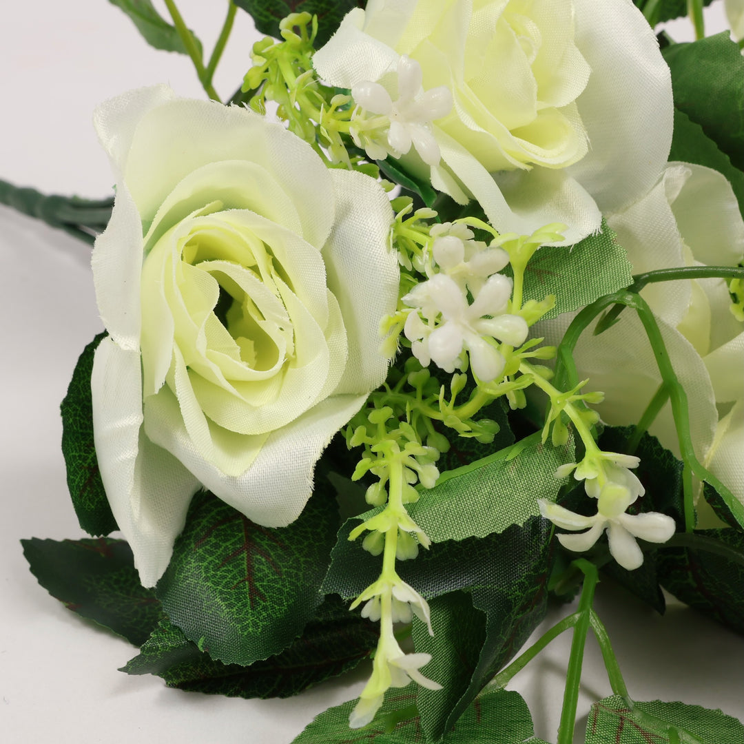 Bouquet of white and green artificial flowers on a light background