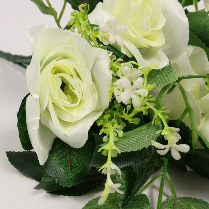 Bouquet of white and green artificial flowers on a light background