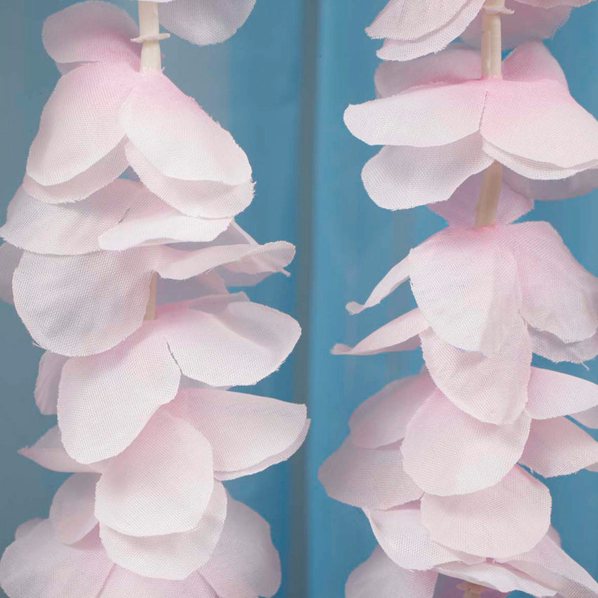 Close up of flower from large orchid hanging vine in blush