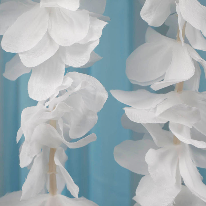 Close up of flower from large orchid hanging vine in white