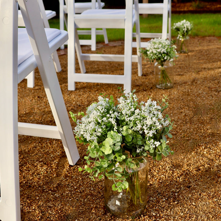 Bunches of Baby's Breath Silver Dollar Small Flower Filler Bouquets in vases next to Americana chairs down outdoor wedding aisle