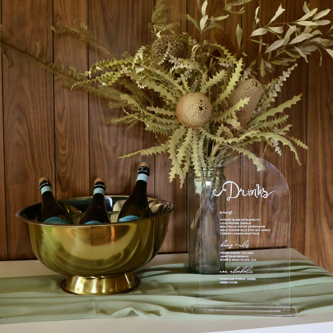 35cm clear acrylic sign on bar with wine in a cooler and native florals