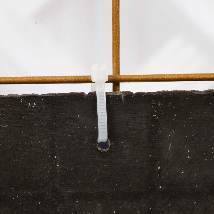 Cable tie attaching shimmer panel to mesh frame through hole