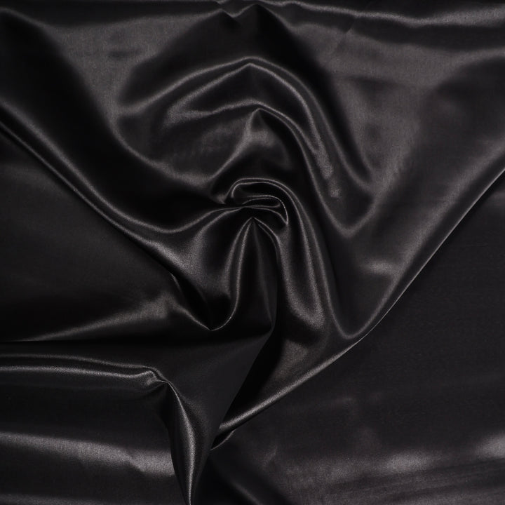 BLACK SATIN FABRIC ROLL CLOSEUP