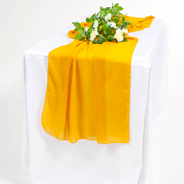 Gold Yellow chiffon runner on white tablecloth with flower vine