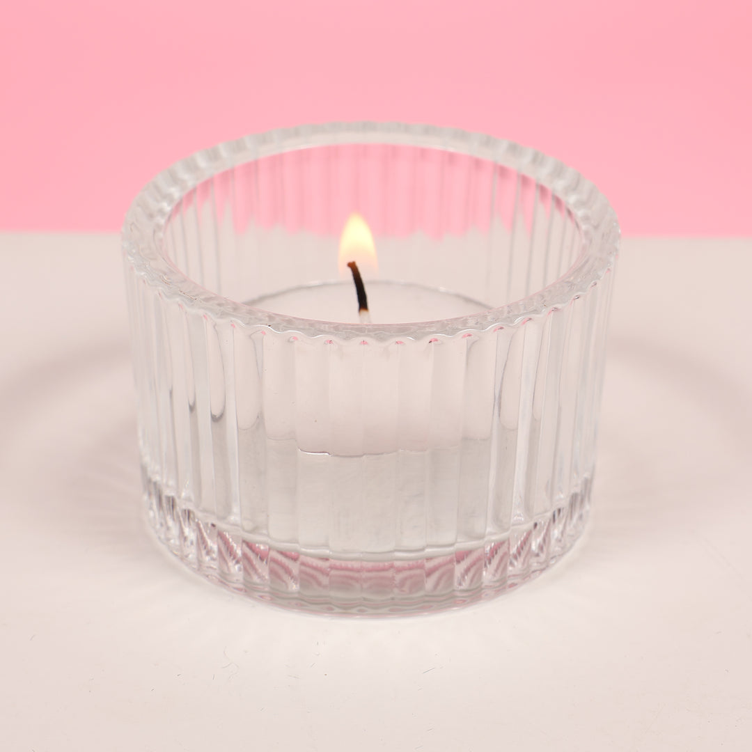 Ribbed Glass Tea Light Candle Holder with candle (side view)