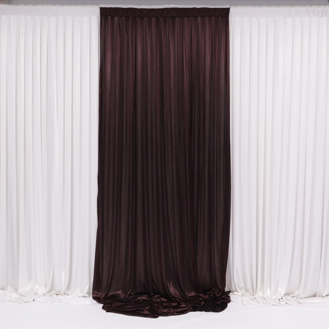 Brown curtain in front of white draped fabric