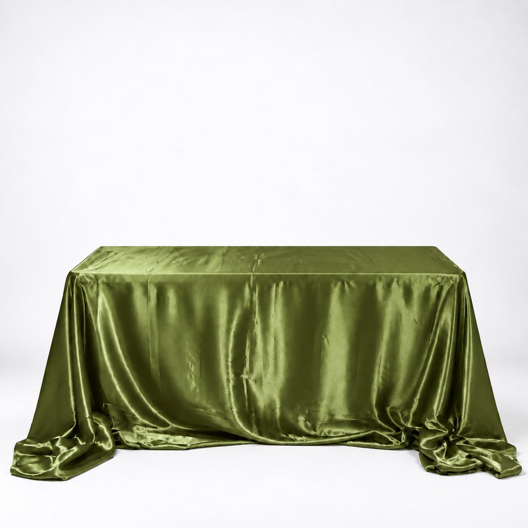 An olive green satin tablecloth draped over a rectangular table against a plain white studio background.