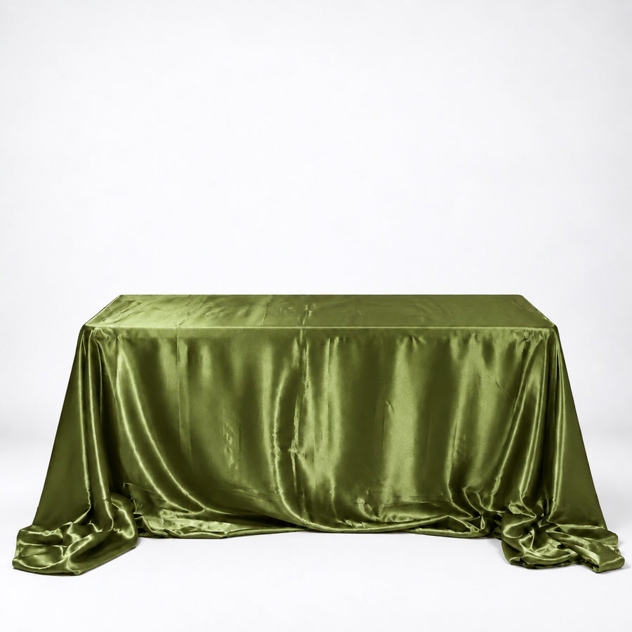 An olive green satin tablecloth draped over a rectangular table against a plain white studio background.