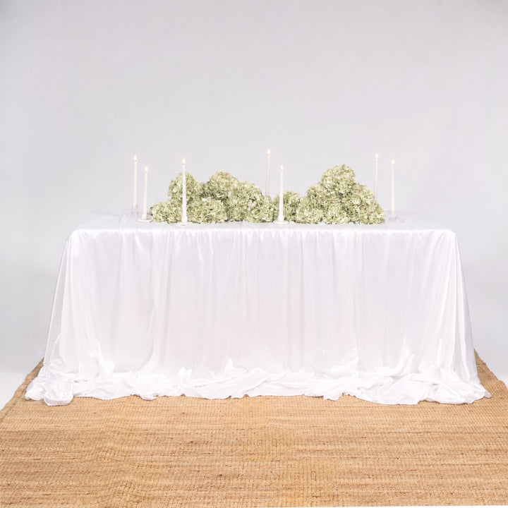 Ice Silk Satin Draping Tablecloth – White (1.5x3m), 3 tablecloths layered to cover 6ft table, with green hydrangeas and white taper candles