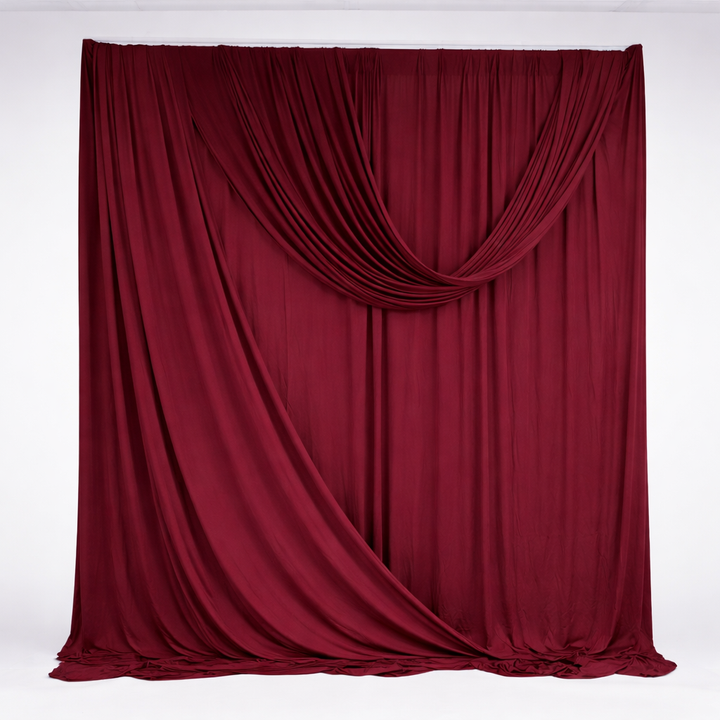 Wine red backdrop panels used to create a backdrop with two draped panels added with backdrop clamps