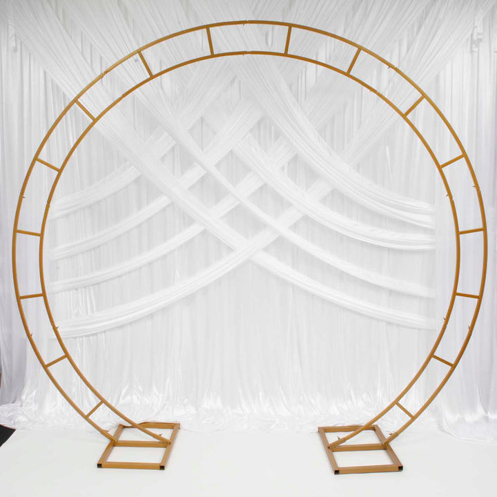 Gold Round Wedding Arch in front of white backdrop