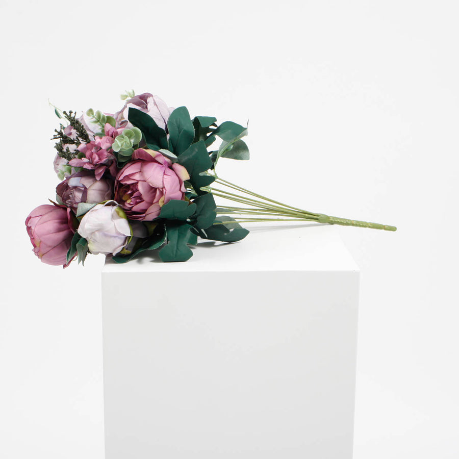 Side veiw of flower bouquet with lavender & mauve coloured roses and green leaves & small round pilea leafs