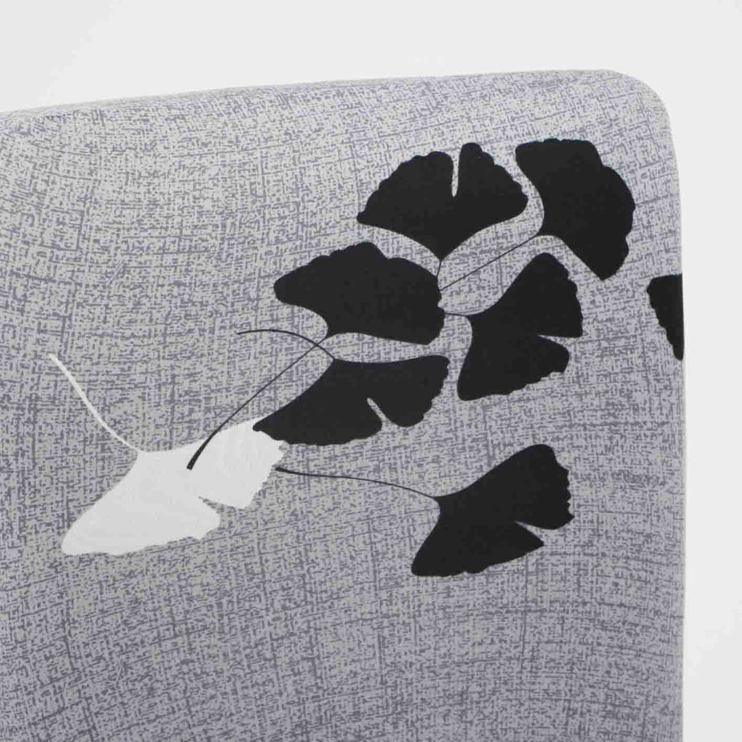 grey chair topper close up of black white leaf design