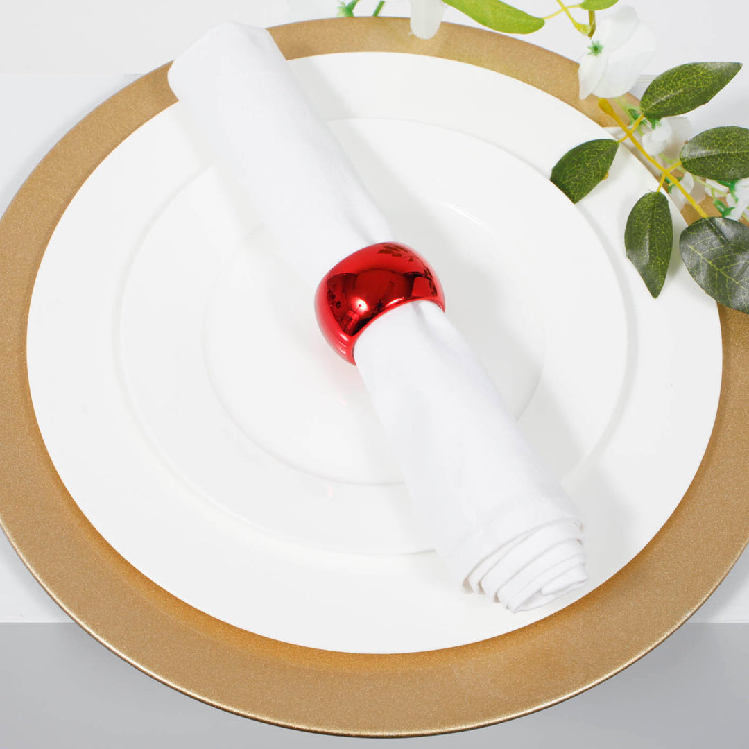 Glitter gold charger plate with white dinner plate and white napkin with metallic red napkin ring