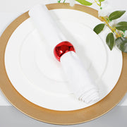 Glitter gold charger plate with white dinner plate and white napkin with metallic red napkin ring