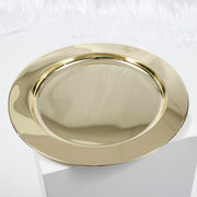 Gold mirror charger plate on white backdrop